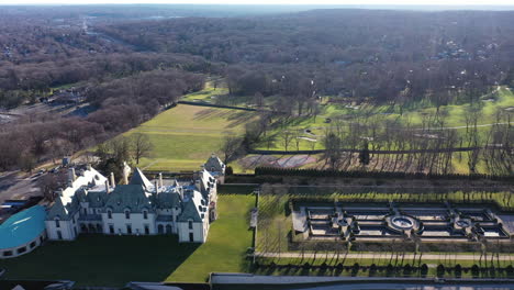 An-aerial-view-over-an-upscale,-luxury-mansion-with-an-eight-reflection-pool-fountain,-on-Long-Island