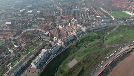 Aerial-view-above-Scarborough-North-bay-houses-on-Yorkshire-small-town-seaside-holiday-resort