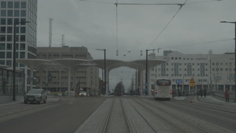 View-through-the-rear-window-of-a-tram-moving-on-empty-streets-during-cold-winter-day