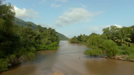 Aerial-View-Of-River-Flowing-In-Forest,-Yelapa,-Jalisco,-Mexico---drone-shot