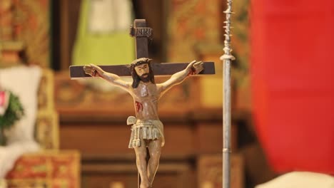 Close-up-shot-of-small-Jesus-Christ-statue-kept-in-the-table-of-church-Bolivia