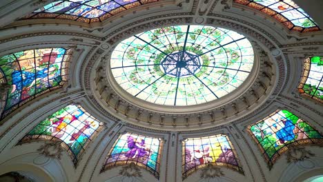 Panning-to-the-right-of-the-stained-glass-windows-of-the-upper-cupola-of-the-Intendencia-de-Santiago,-current-seat-of-the-Presidential-Delegation,-Santiago,-Chile