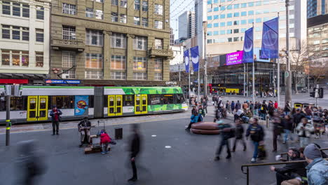 Time-lapse-of-tram-passengers,-pedestrians,-a-busker-and-shoppers-in-Bourke-St-Mall