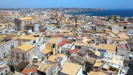 Revealing-drone-shot-of-Syracuse-coastline,-historic-city-on-the-Italian-island-of-Sicily