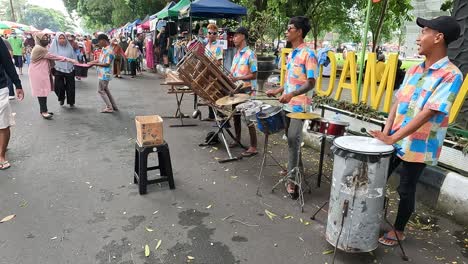 Musicians-play-traditional-Indonesian-instruments-on-street,-Magelang