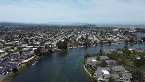 Drone-Flying-Over-Blue-Lagoon-Path,-Huge-Number-Of-Villas-On-Both-Sides,-San-Mateo