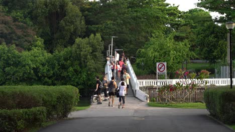 People-walking-at-Changi-Point-Bridge,-Changi-Beach-Park-in-Singapore