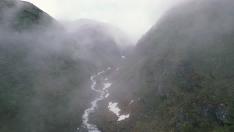 Vuelo-Aéreo-A-Través-De-La-Niebla-En-El-Barranco-Verde-En-El-Parque-Nacional-Hardangervidda,-Eidfjord,-Noruega