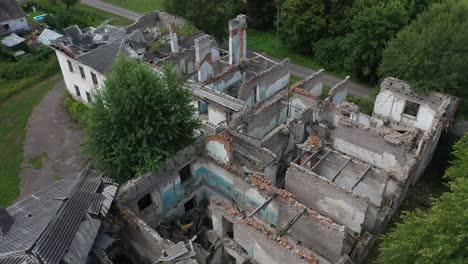 Close-drone-video-of-roofless-abandoned-houses-in-a-lonely-village-with