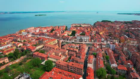 Stunning-scenic-view-of-vibrant-red-rooftops-of-Venice-Italy,-4k-drone