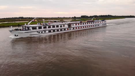 Aerial-Port-Side-View-Of-Olympia-Cruise-Ship-Along-River-Noord