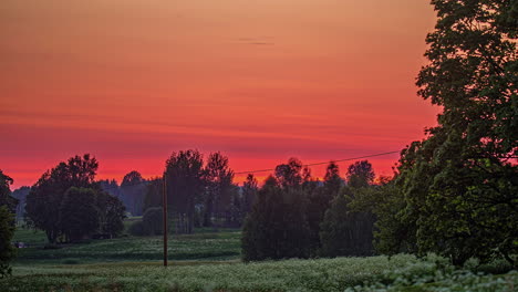 Red-Sky-During-Sunset-Over-Rual-Fields-And-Trees