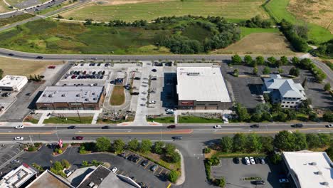 Overhead-aerial-shot-of-cars-driving-along-the-main-strip-in-Oak-Harbor,-Washington