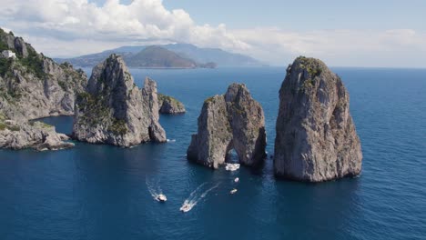 Faraglioni-Arch-Rock-Formations-on-Capri-Island-Coast,-Italy---Aerial