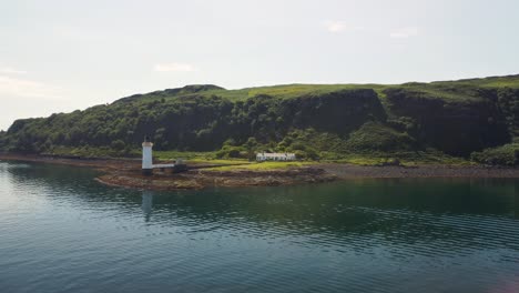 Aerial-wide-shot-of-the-Tobermory-Lighthouse-and-the-Isle-of-Mull-coastline