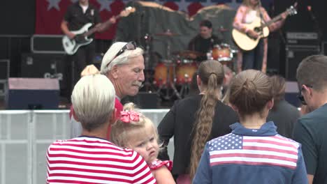 Taste-of-Madison-Little-girl-being-held-and-title-up-to-Musician-playing