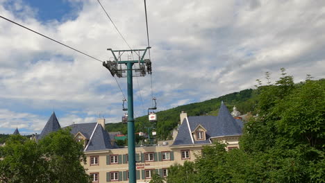 Destino-Turístico-En-Quebec,-Canadá,-Teleférico,-Teleférico,-Vista-De-La-Cabina-Del-Teleférico,-Levantándose-Ascendente-Sobre-Un-Hotel-De-Montaña-En-La-Región-De-Mont-tremblant,-Turismo-Y-Ocio