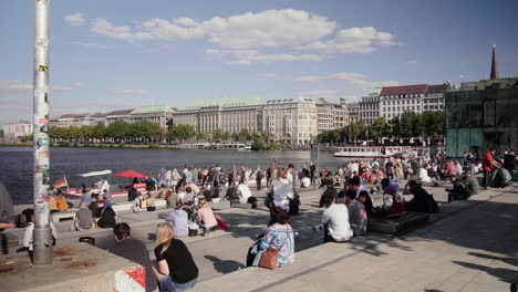 Gente-Reunida-En-Pasos-En-Hamburgo-Jungfernstieg-Vista-De-Binnen-Alster-En-Un-Día-Soleado