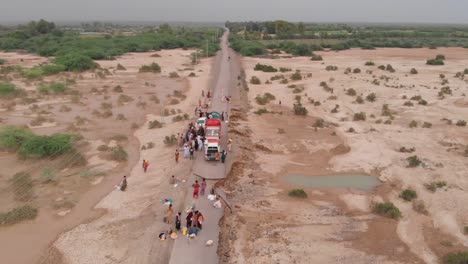 Aerial-View-Of-Truck-Providing-Food-Aid-After-Flood-In-Remote-Area-In-Balochistan