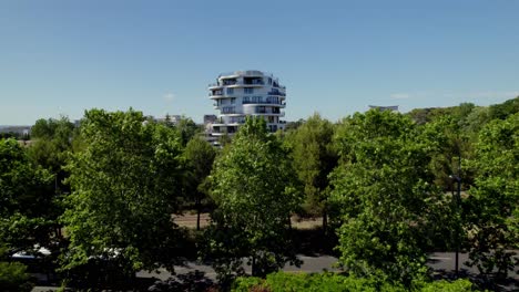 Apartment-building-behind-some-trees-in-Montpellier,-France