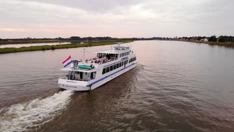 Aerial-View-Of-Smaragd1-Party-ship-Going-Past-On-River-Noord