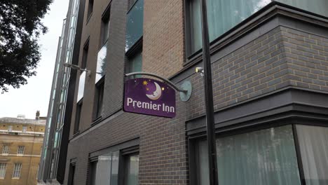City-of-London-England-September-2022-Establishing-shot-of-Premier-Inn-logo-hanging-from-hotel-facade