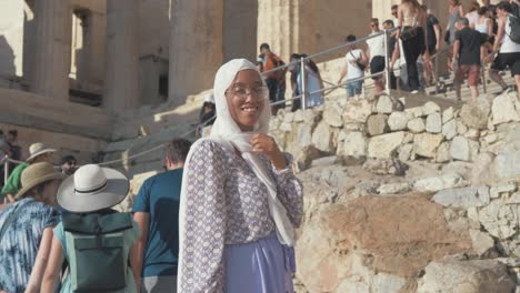 Beautiful-stylish-Muslim-woman-in-front-of-Proplylaea-gateway-Athens