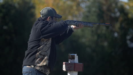 A-man,-at-a-shooting-range,-firing-a-round-at-a-flying-target-with-a-rifle,-but-missing-it-and-showing-his-disappointment