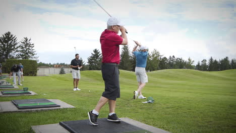 Golfer-teeing-off-on-the-driving-range-in-slow-motion