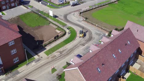 Aerial-fly-though-of-the-Redrow-homes-development,-Manor-Park-in-Rainham,-Kent-tracking-a-mini-digger