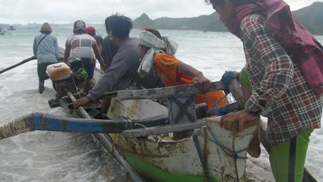 Slow-motion-of-fisherman-in-Indonesia-island-going-to-see-on-a-traditional-boat-and-water-splashing-on-the-camera