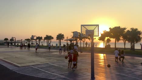 Spielen-Sie-Bei-Sonnenuntergang-Basketball-Auf-Den-Plätzen-Am-Meer,-Ort:-Chatan,-Okinawa,-Japan