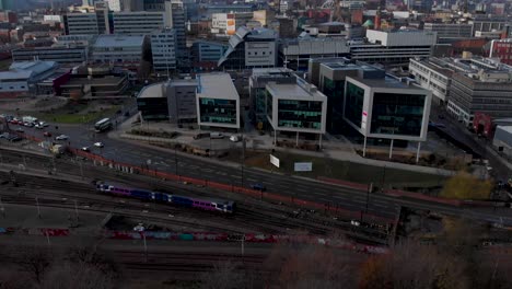 Drone-shot-above-the-city-of-Sheffield,-panning-over-the-Train-Station,-Sheffield-Hallam,-Park-Hill-and-more