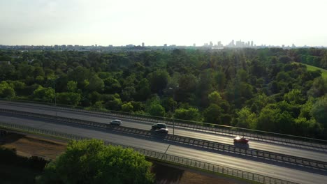 Aerial-top-down-view-of-traffic-jam-on-a-car-bridge-and-moving-train