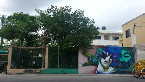 Bike-Taxi-And-Collectivo-Van-Driving-By-Graffiti-Wall-In-Downtown-Mexico