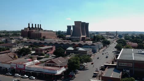 A-push-up-drone-shot-an-industial-city-section-in-Bulawayo,-Zimbabwe-under-sunny-conditions