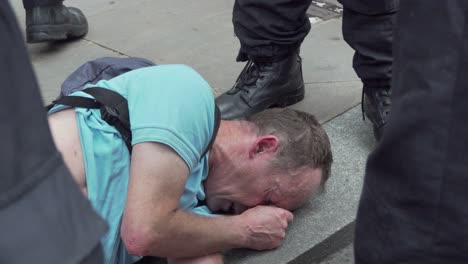 A-Tommy-Robinson-supporter-is-knocked-to-the-ground-whilst-being-arrested-along-Whitehall,-London