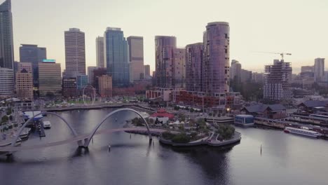 Cinematic-aerial-view-of-Elizabeth-Quay,-a-new-modern-river-coast-and-bay-build-in-2019-with-camera-moving-circular-and-upwards-revealing-skyscrapers-and-the-skyline-of-Perth-in-Western-Australia