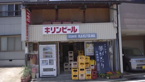 Small-general-storefront-building-on-local-Japanese-road,-urban-scene