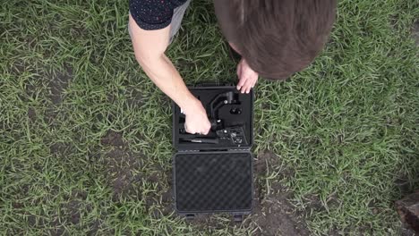 A-man-setting-up-and-using-a-stabilizer-to-take-video-at-a-construction-site