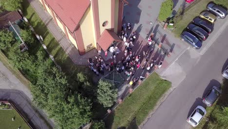 Aerial-shot-of-a-wedding-ceremony-in-a-small-church-on-a-coutryside