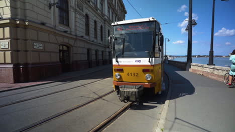 Handheld-following-shot-as-tram-pulls-out-of-stop-and-heads-into-the-distance