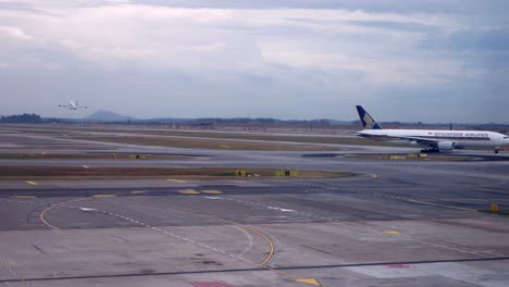 Landscape-view-of-Singapore-airport-with-Singapore-airline's-plane-taxing-in-Singapore-Changi-Airport