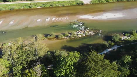 Dronie-from-from-chill-Isar-Flaucher-Nudist-Beach-in-Germany,-Munich