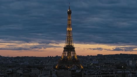 High-level-view-of-the-Eiffel-Tower-rising-above-the-rooftops-of-Paris,-France