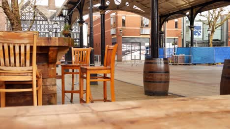 Empty-city-pub-seating-barrels---wooden-seats-outdoor-urban-scene-slow-dolly-left