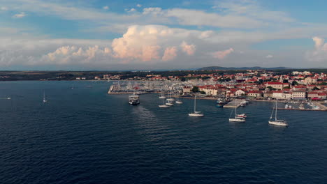 Sailboats-in-the-Mediterranean-Sea-out-of-the-coast-in-Zadar-Croatia,-with-copy-space