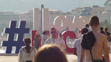 Ich-Liebe-Schöne-Schilder-An-Der-Französischen-Riviera-Und-Touristen,-Die-Auf-Dem-Boulevard-Spazieren-Gehen