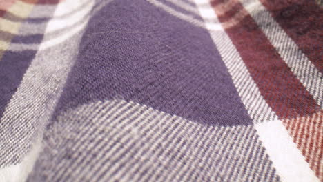 Close-up-slide-across-the-fabric-of-a-plaid-shirt