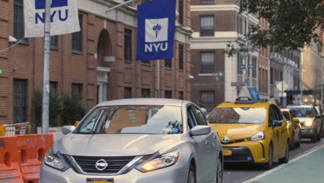 Traffic-moving-past-NYU-in-Greenwich-Village,-New-York